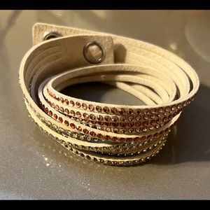 Swarovski light pink wrap bracelet with gold buttons.